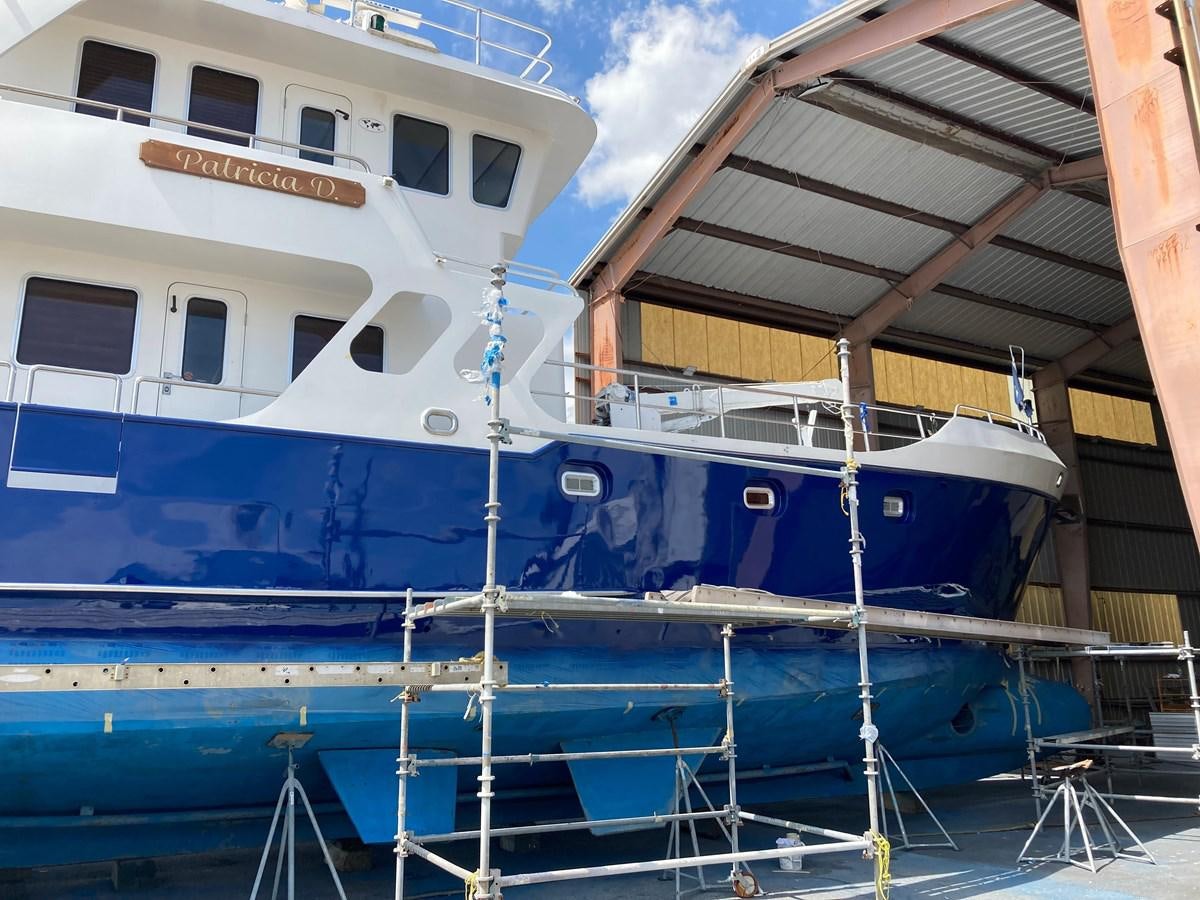 a boat docked at a pier aboard PATRICIA D Yacht for Sale