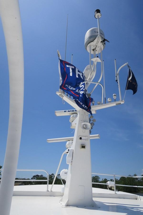 a satellite dish with a flag on it aboard PATRICIA D Yacht for Sale