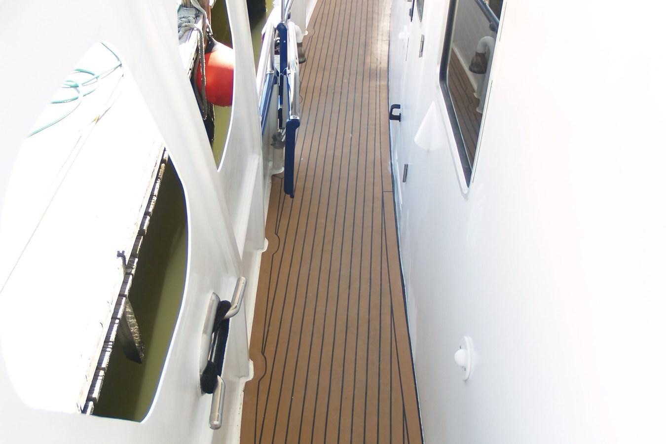 a long hallway with a few doors aboard PATRICIA D Yacht for Sale