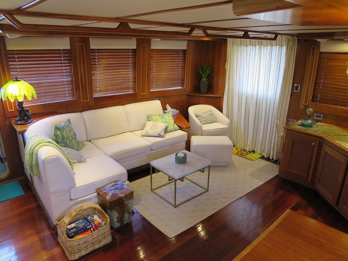 a living room with a couch and a table aboard PATRICIA D Yacht for Sale