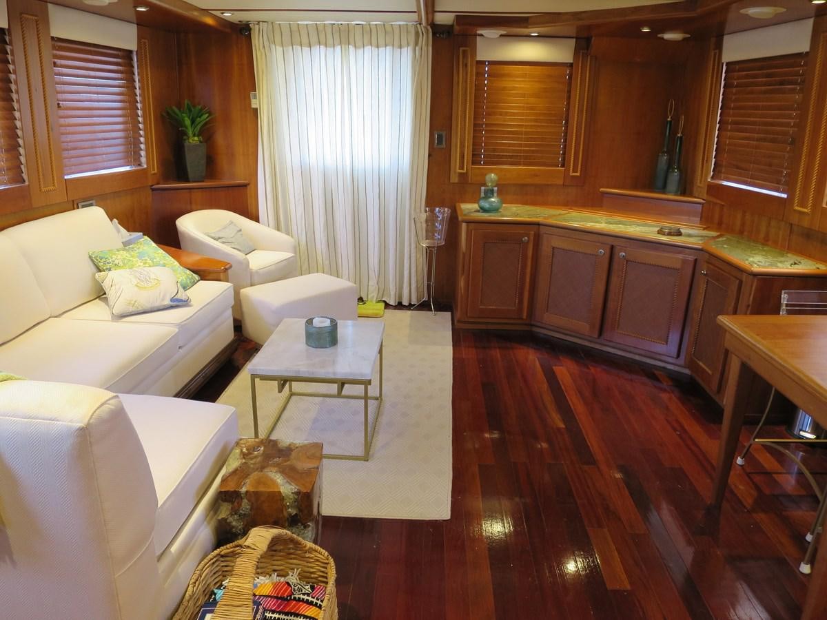 a living room with a wood floor aboard PATRICIA D Yacht for Sale