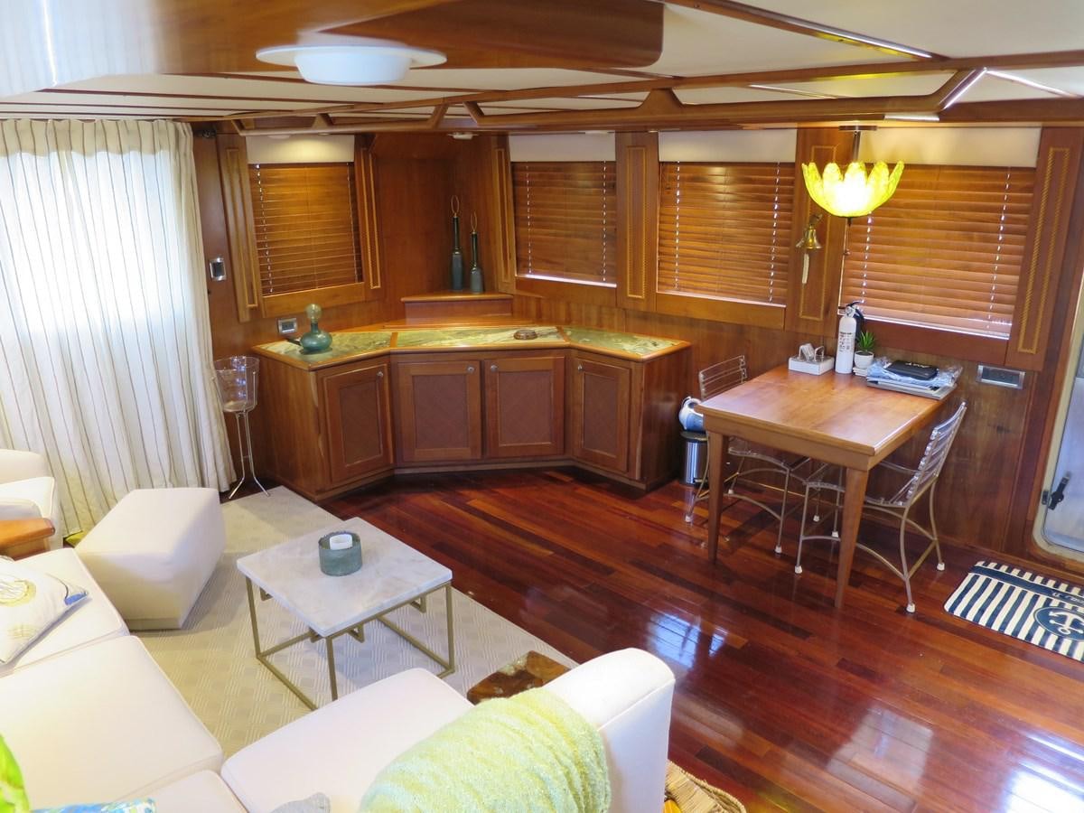 a room with a table chairs and a couch aboard PATRICIA D Yacht for Sale