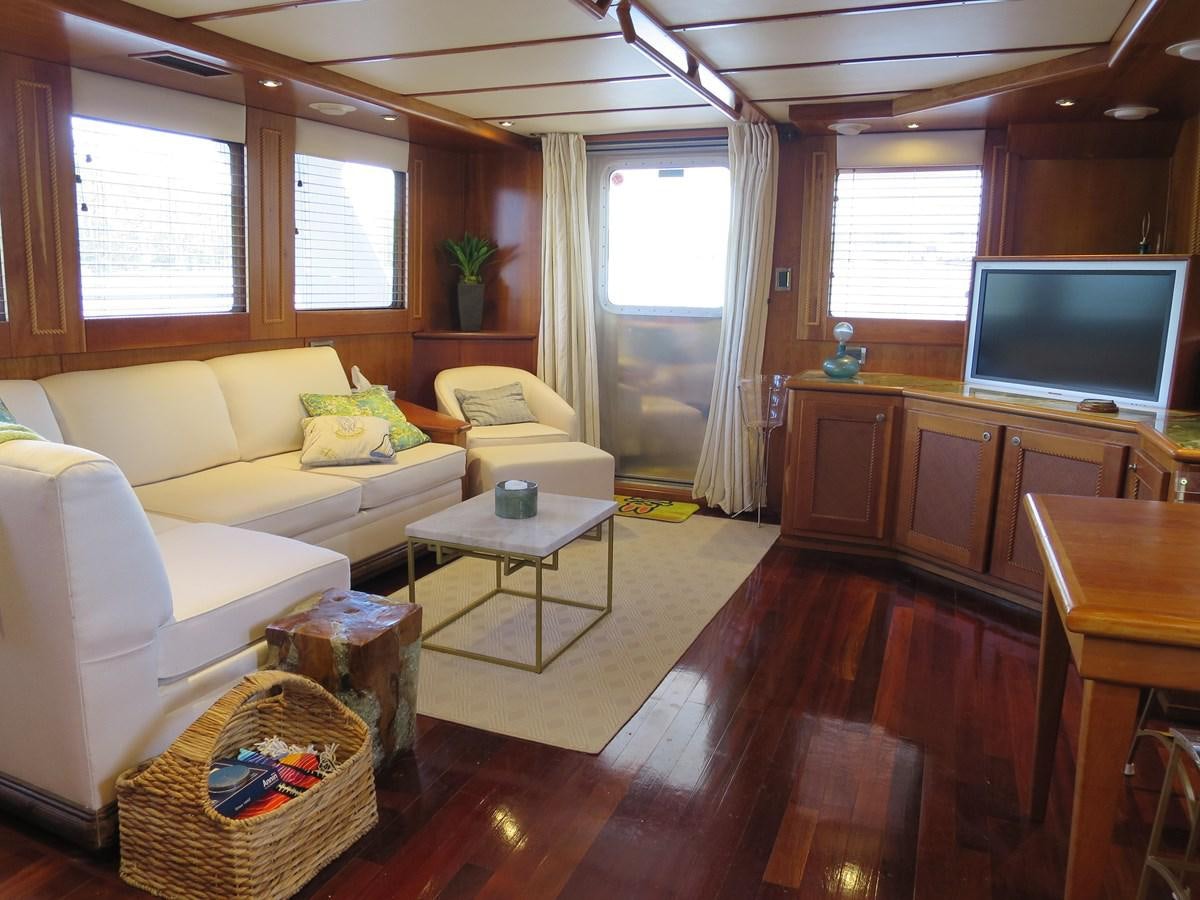 a living room with a wood floor aboard PATRICIA D Yacht for Sale