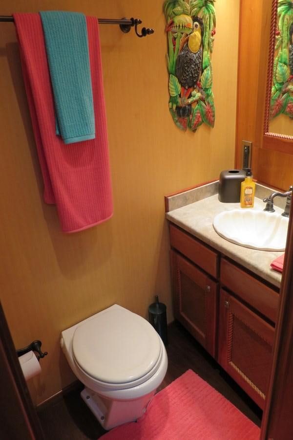 a bathroom with a toilet and sink aboard PATRICIA D Yacht for Sale