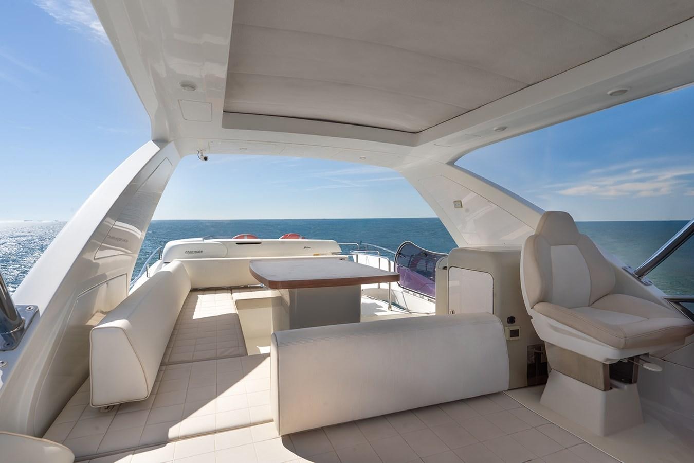 a boat with a table and chairs aboard ELENA I Yacht for Sale