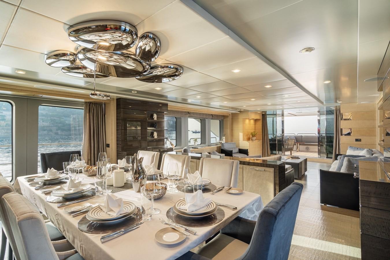 a large dining room with a chandelier aboard EDESIA Yacht for Sale