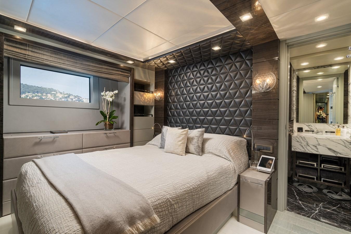 a bedroom with a bed and a television aboard EDESIA Yacht for Sale