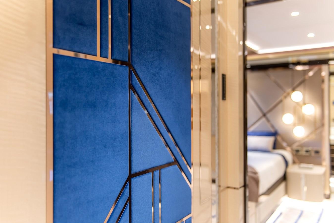 a room with a blue wall and a staircase aboard STEFANIA Yacht for Sale