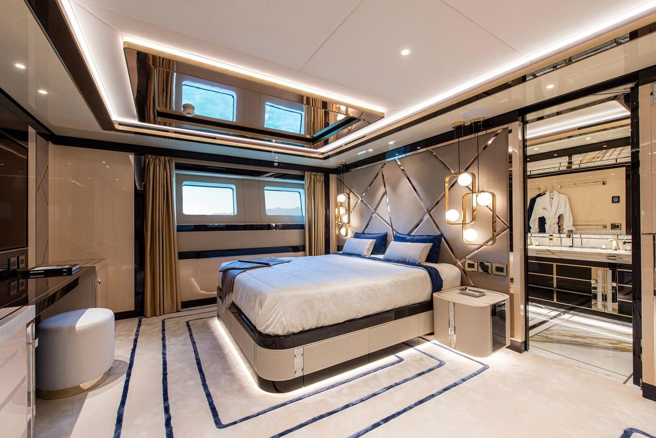 a room with a bed and a large mirror aboard STEFANIA Yacht for Sale