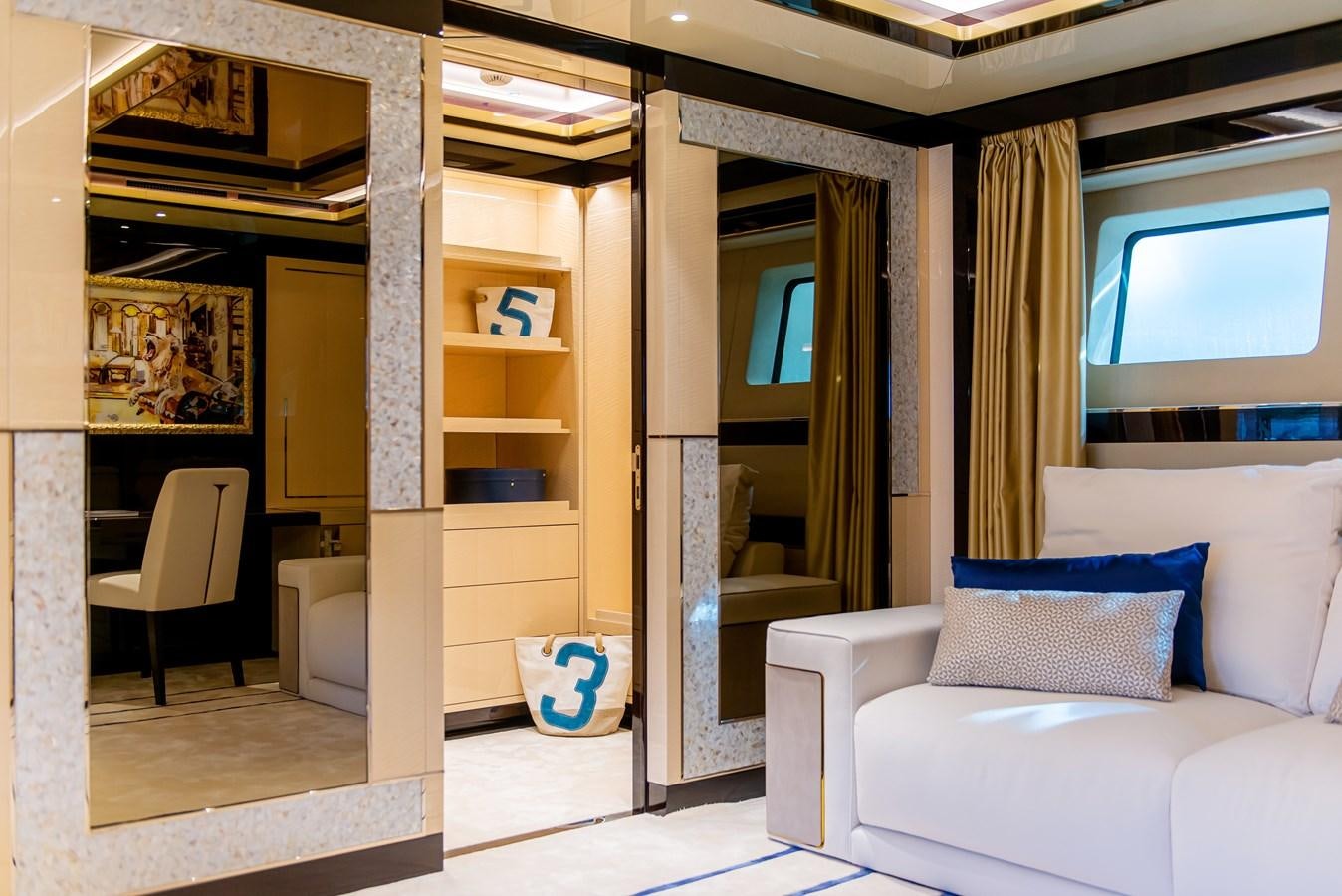 a living room with a white couch and a wood door aboard STEFANIA Yacht for Sale