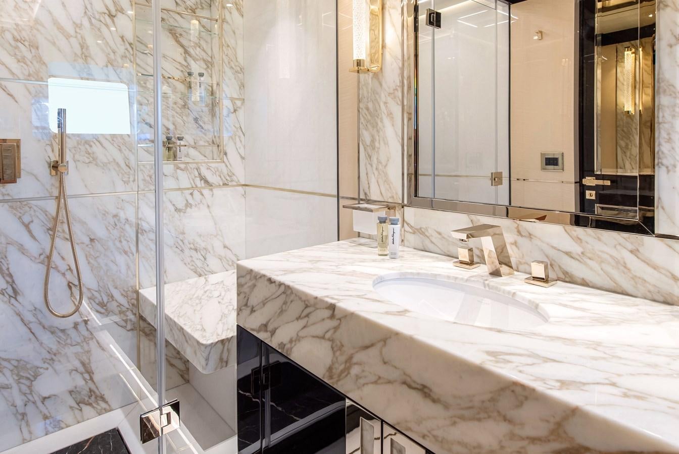 a bathroom with a tub sink and mirror aboard STEFANIA Yacht for Sale