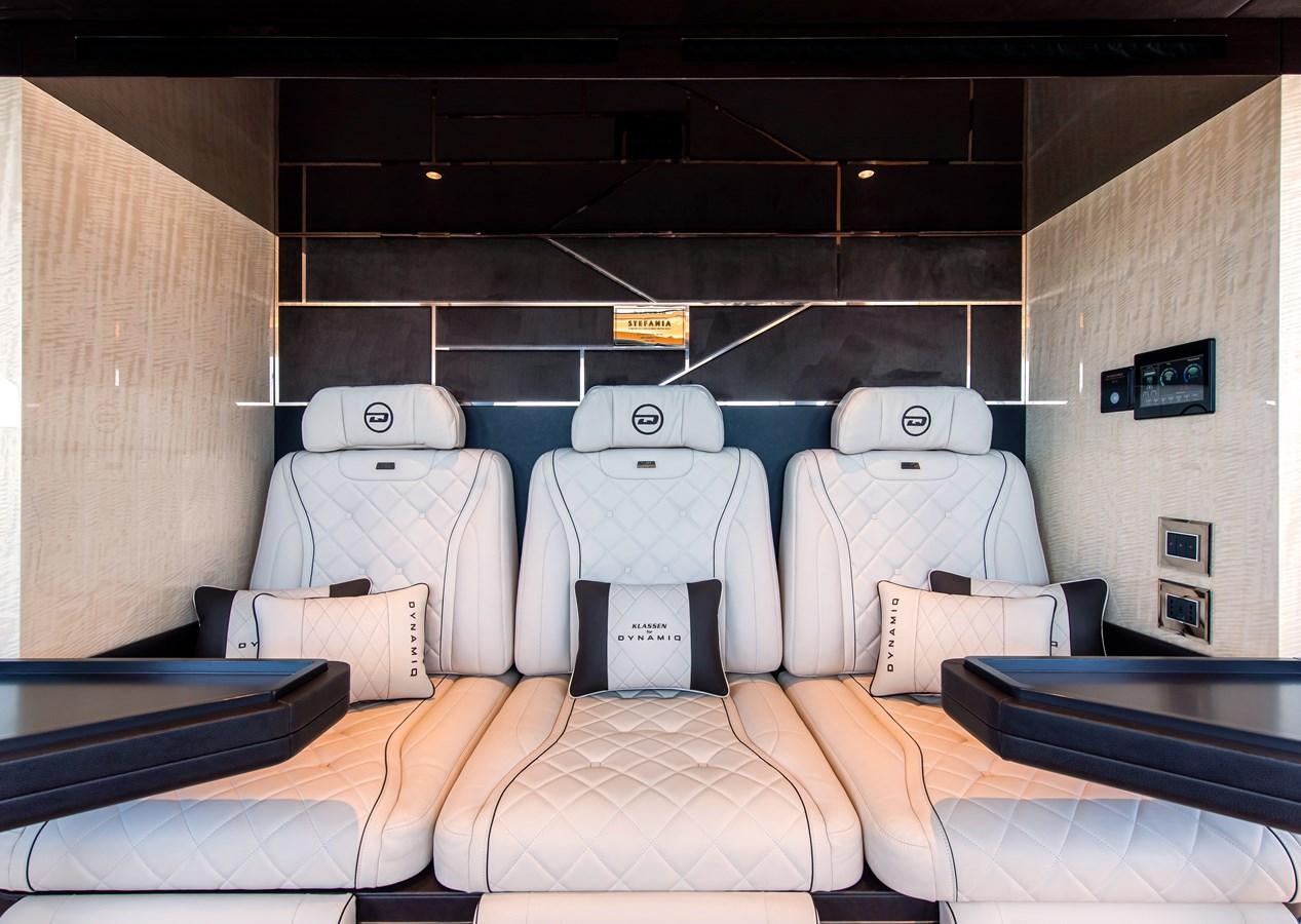 a group of white chairs on a bed aboard STEFANIA Yacht for Sale