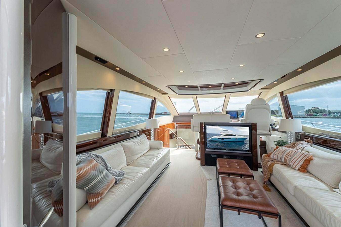 a large white room with a couch and a table aboard LATITUDE Yacht for Sale