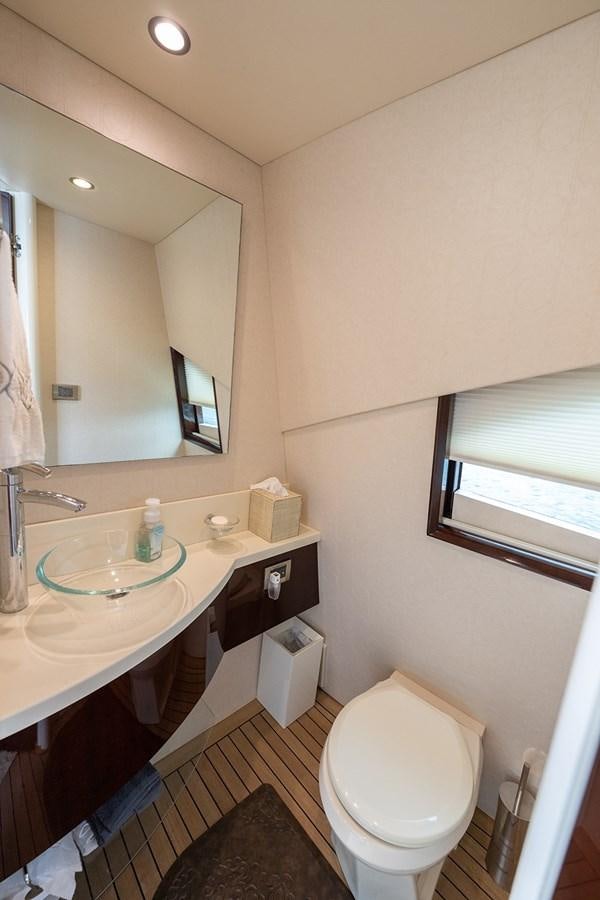 a bathroom with a sink and a toilet aboard LATITUDE Yacht for Sale