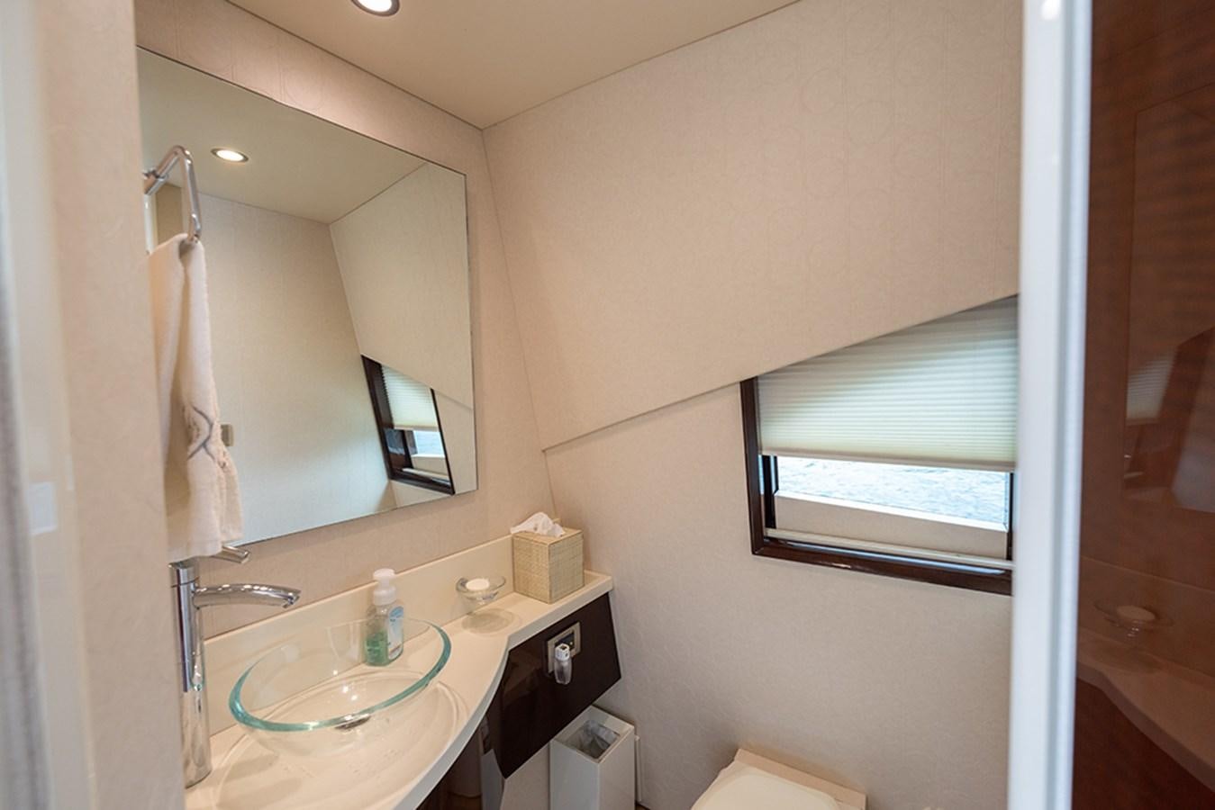 a bathroom with a sink and a mirror aboard LATITUDE Yacht for Sale