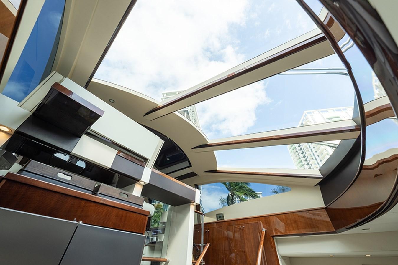 a room with a window and a television on the wall aboard LATITUDE Yacht for Sale