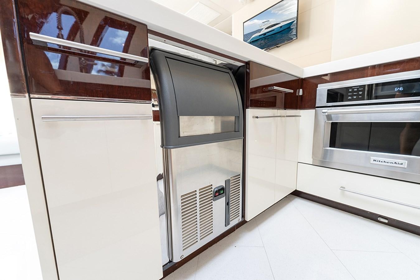 a kitchen with white cabinets aboard LATITUDE Yacht for Sale