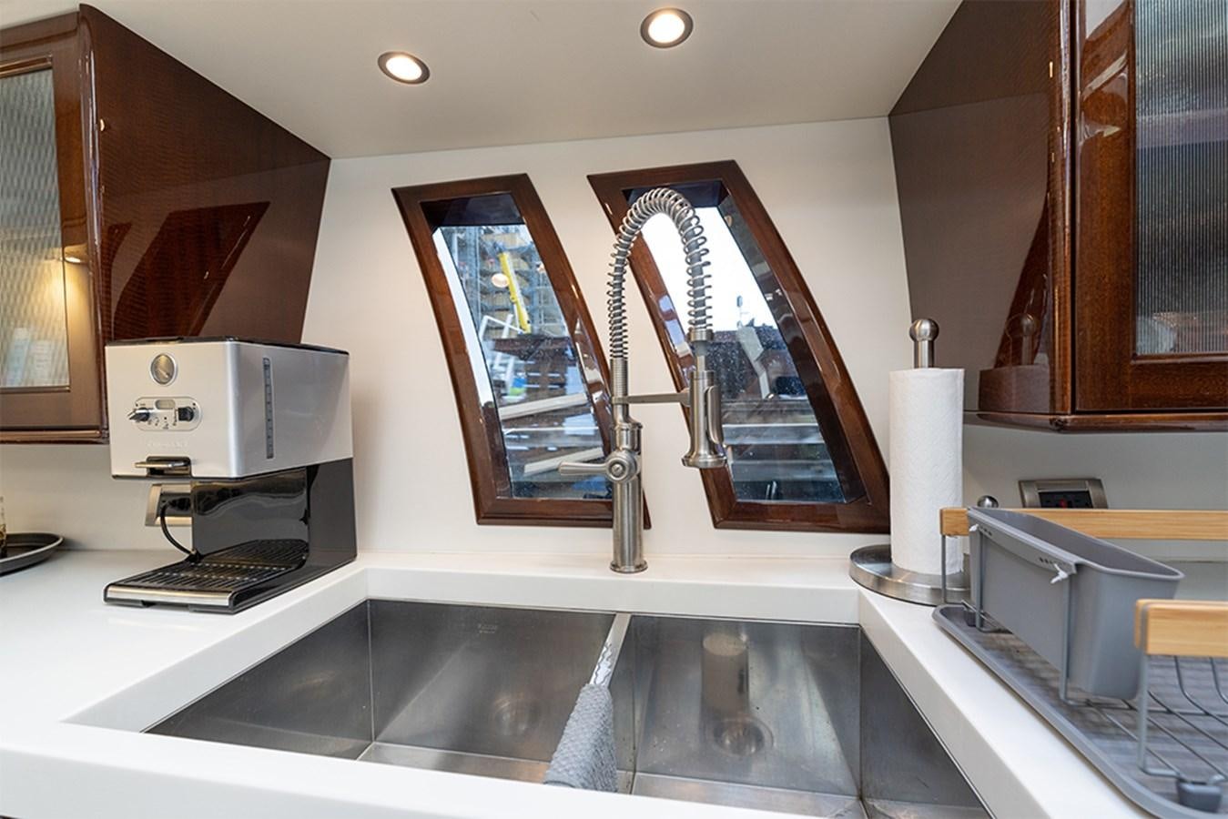 a kitchen with a large window aboard LATITUDE Yacht for Sale