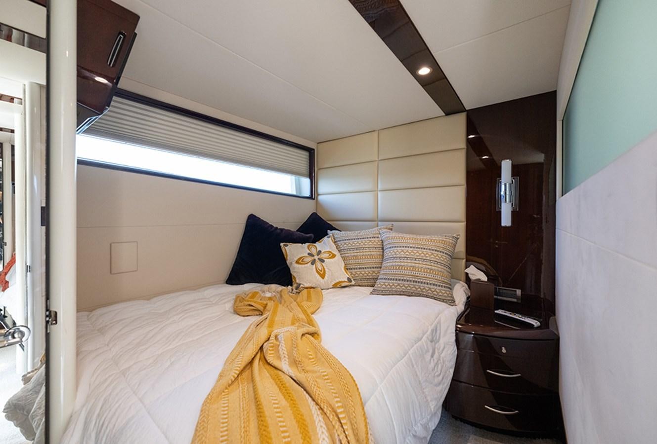 a bed with a white sheet and pillows aboard LATITUDE Yacht for Sale