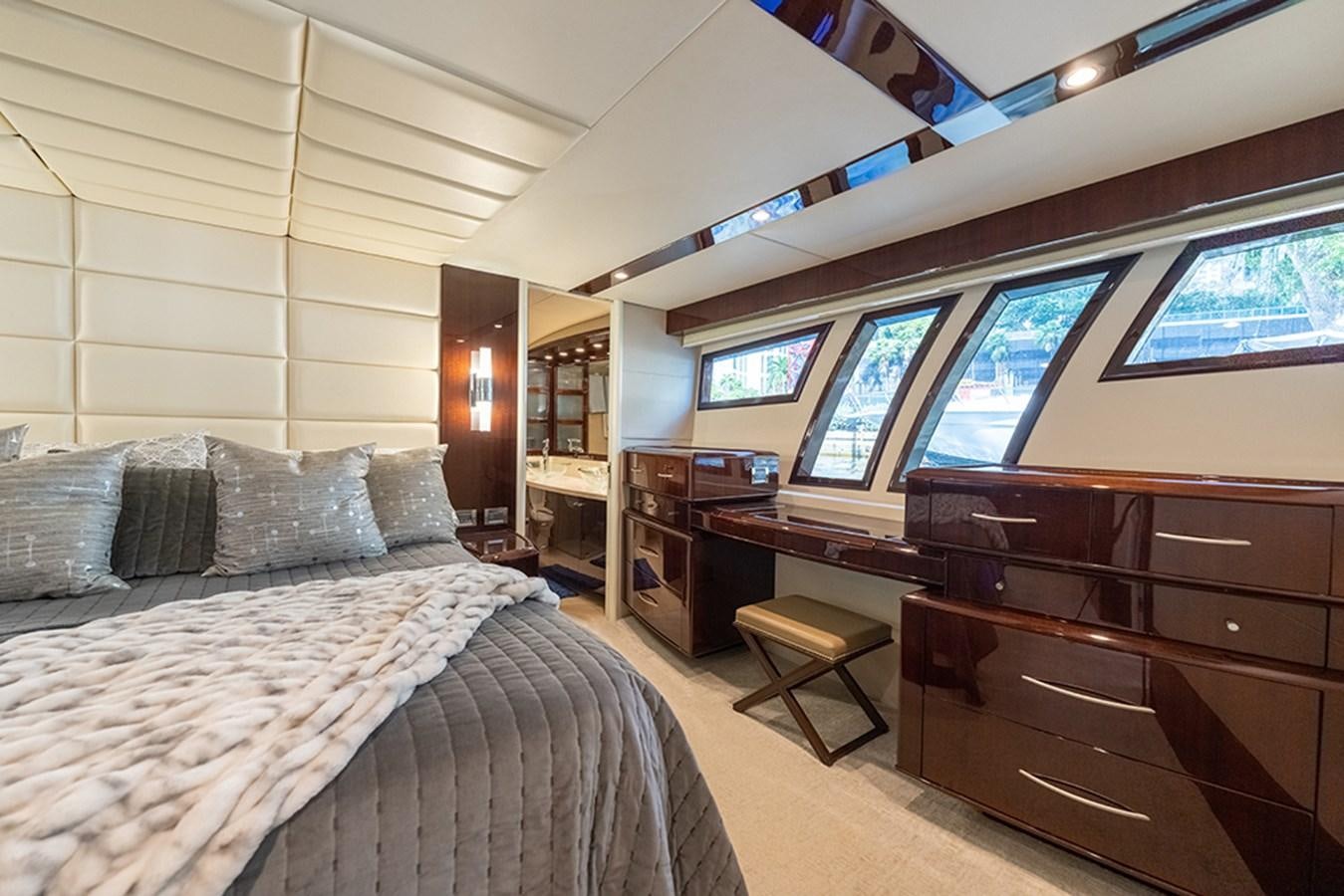 a bedroom with a bed and a desk aboard LATITUDE Yacht for Sale