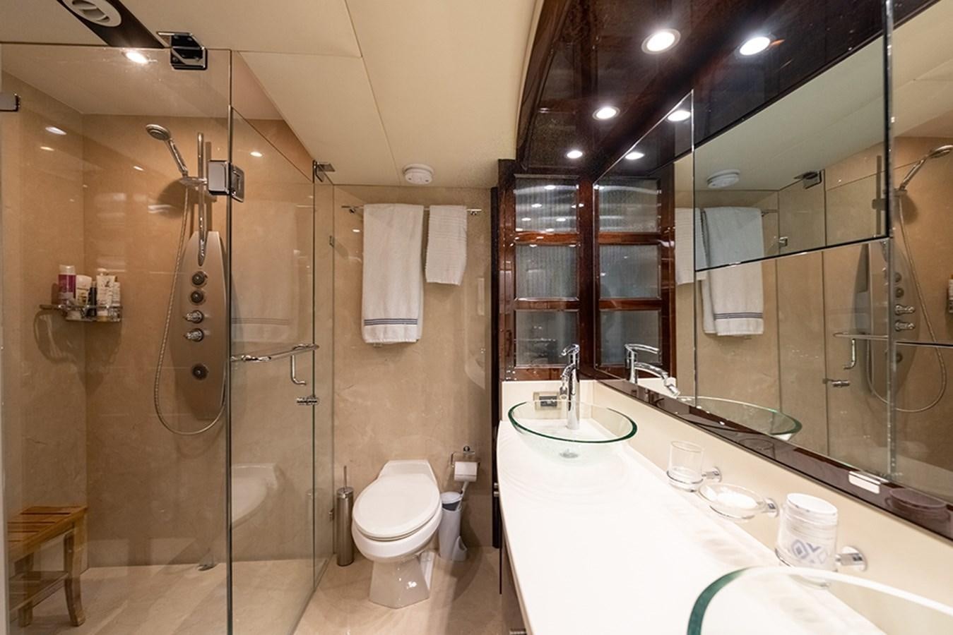 a bathroom with a glass shower aboard LATITUDE Yacht for Sale