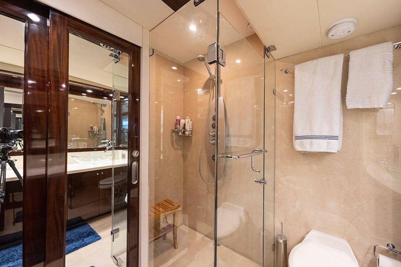 a bathroom with a glass shower aboard LATITUDE Yacht for Sale