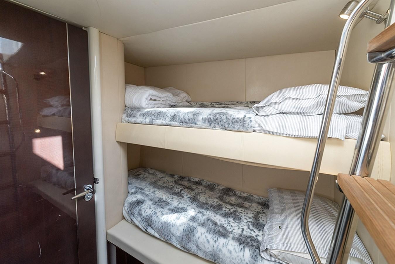 a bed with white sheets aboard LATITUDE Yacht for Sale