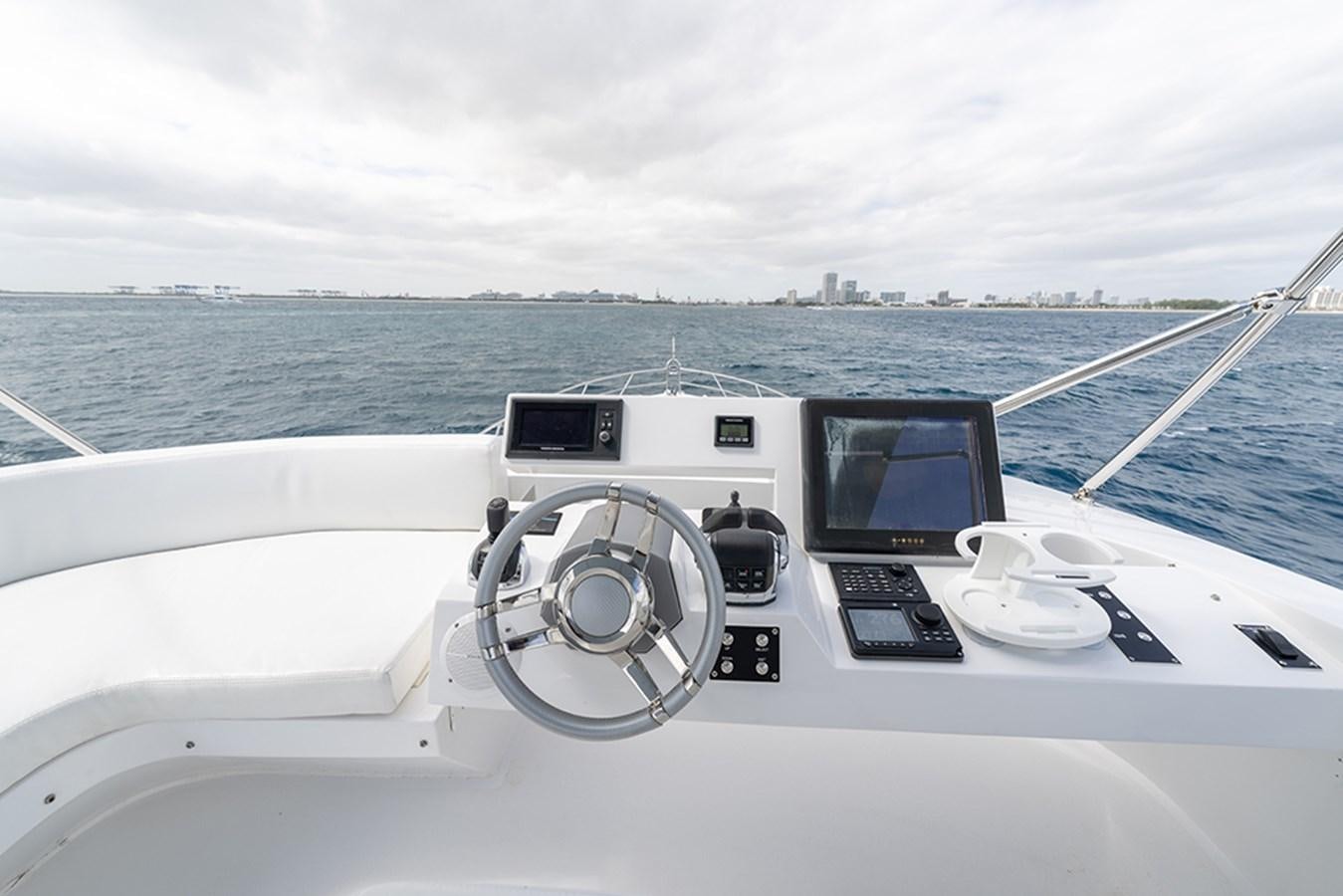 a boat with a steering wheel and dashboard aboard LATITUDE Yacht for Sale