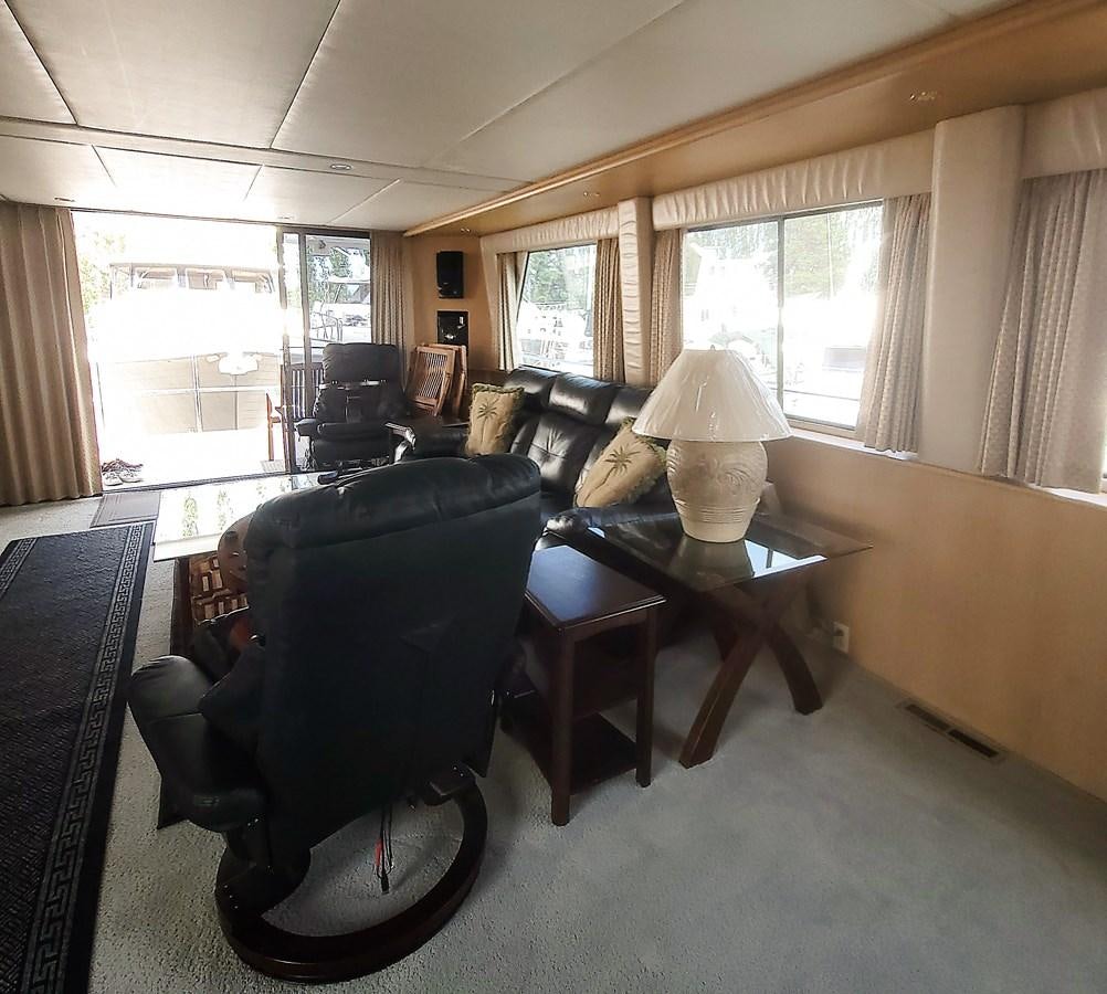 a living room with a black chair aboard AUDRE GRACE Yacht for Sale