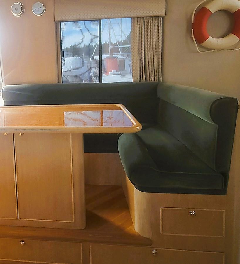 a green couch in a room aboard AUDRE GRACE Yacht for Sale
