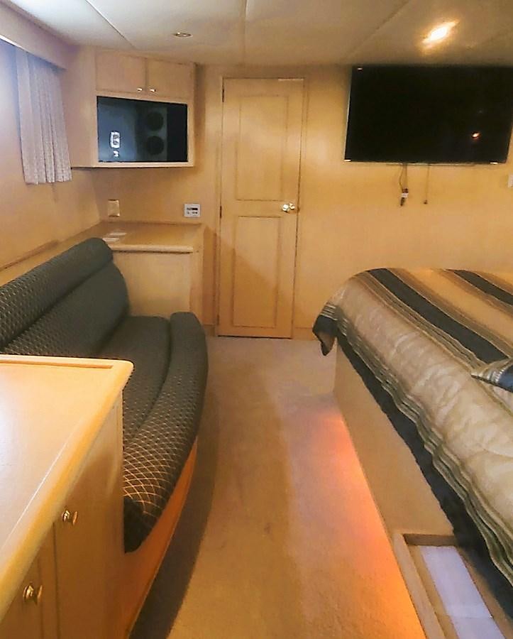a living room with a couch and a television aboard AUDRE GRACE Yacht for Sale