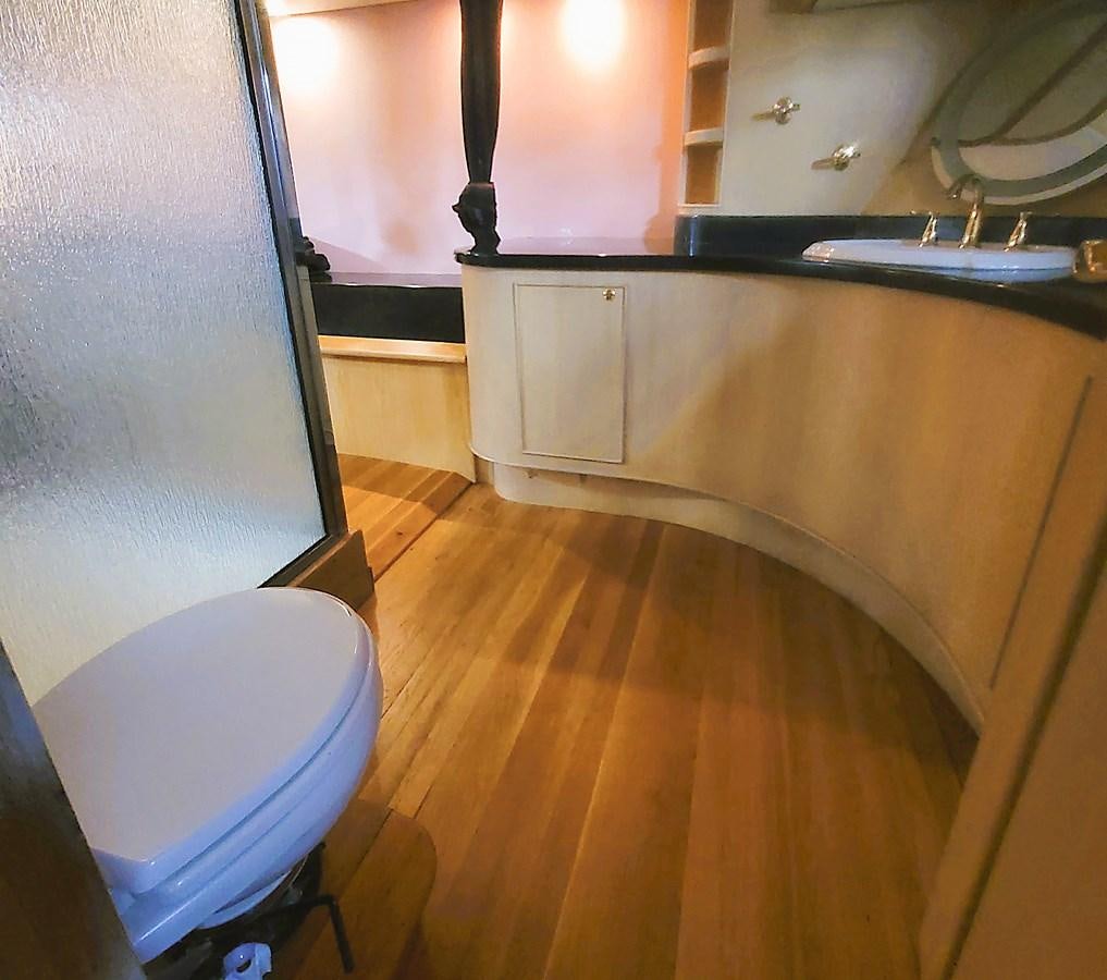 a bathroom with a toilet and a sink aboard AUDRE GRACE Yacht for Sale