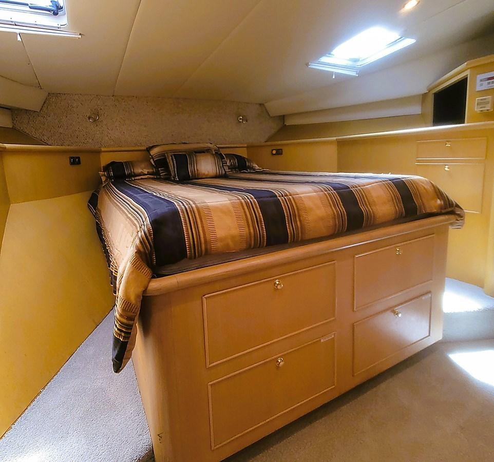 a bed with a wooden frame aboard AUDRE GRACE Yacht for Sale