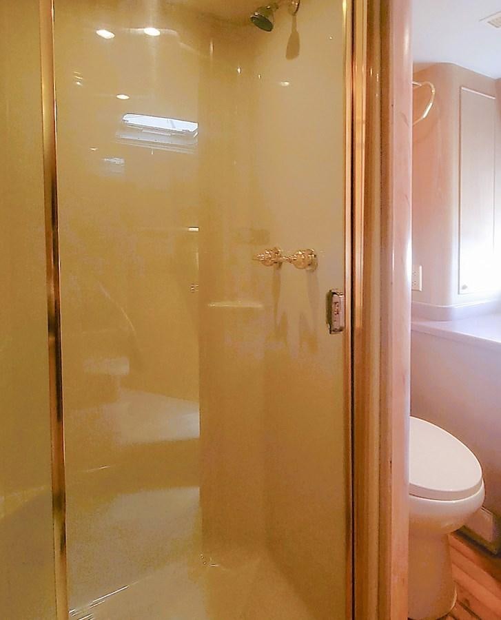 a bathroom with a glass shower door aboard AUDRE GRACE Yacht for Sale