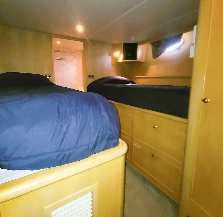 a bedroom with a blue bed aboard AUDRE GRACE Yacht for Sale