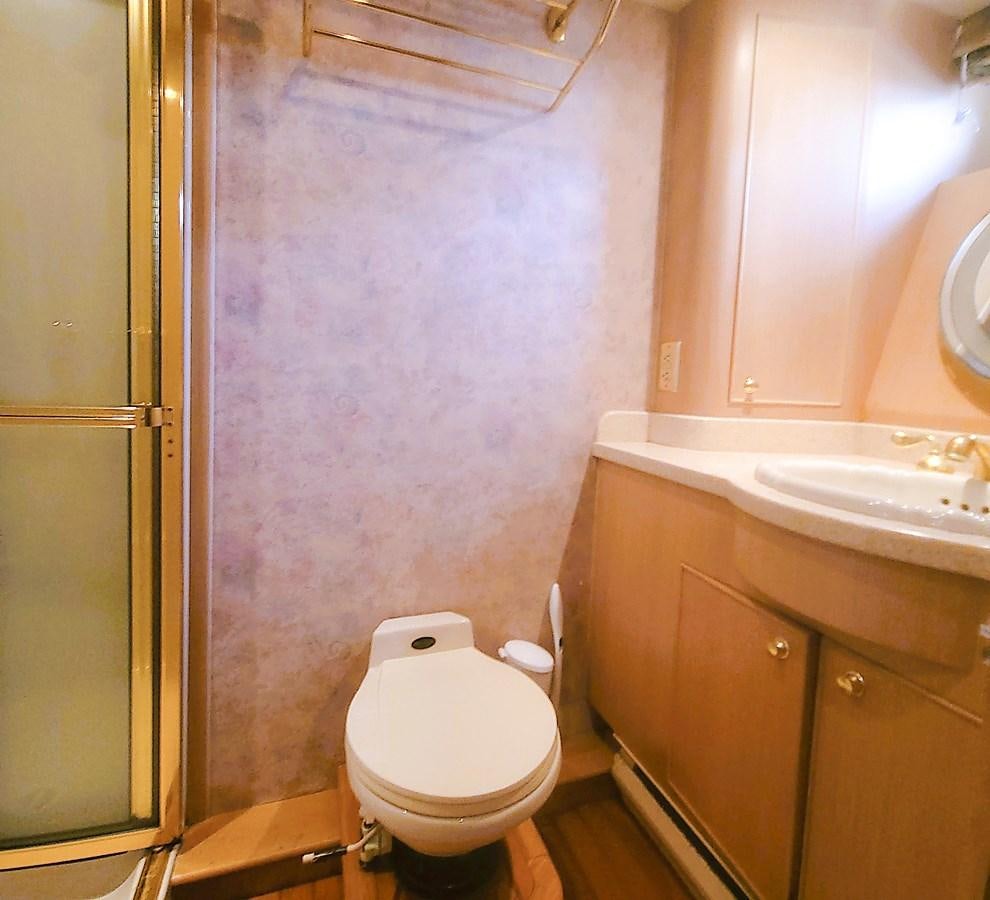 a bathroom with a toilet and sink aboard AUDRE GRACE Yacht for Sale