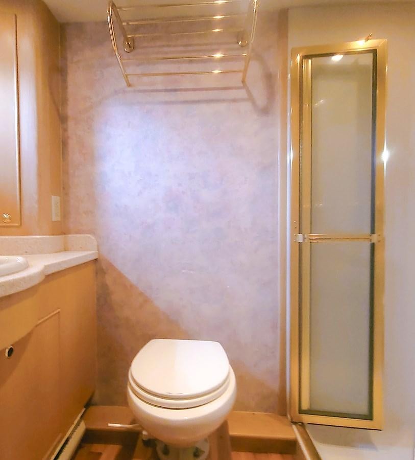 a bathroom with a toilet and sink aboard AUDRE GRACE Yacht for Sale