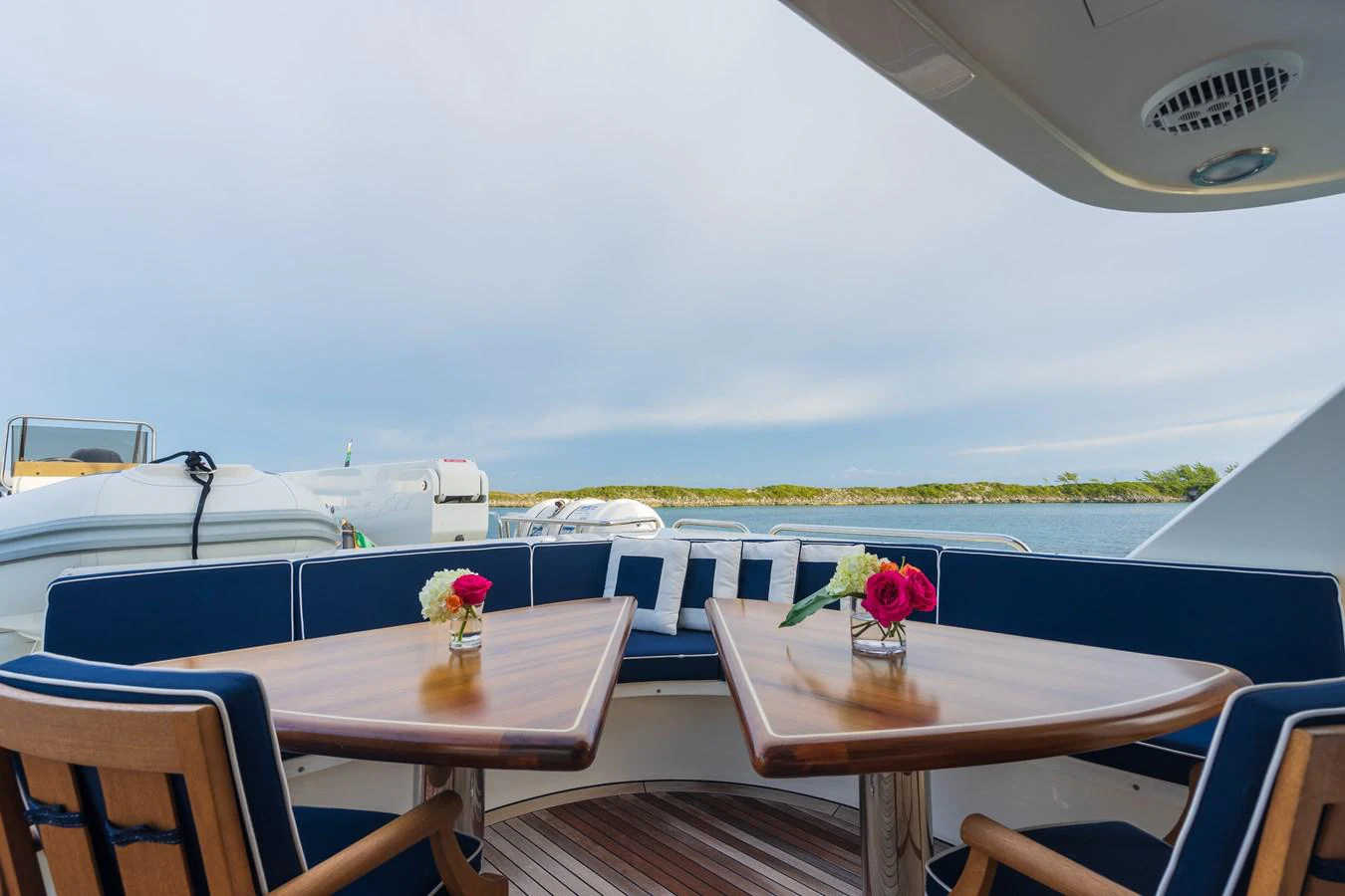 a room with tables and chairs aboard DONA LOLA Yacht for Sale
