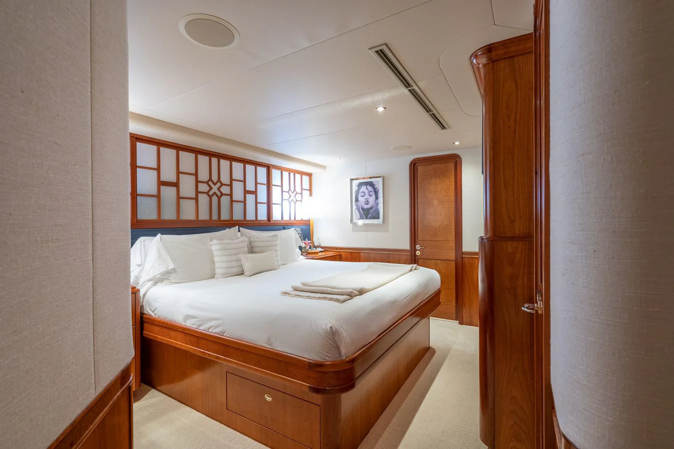 a bedroom with a bed and a door aboard DONA LOLA Yacht for Sale