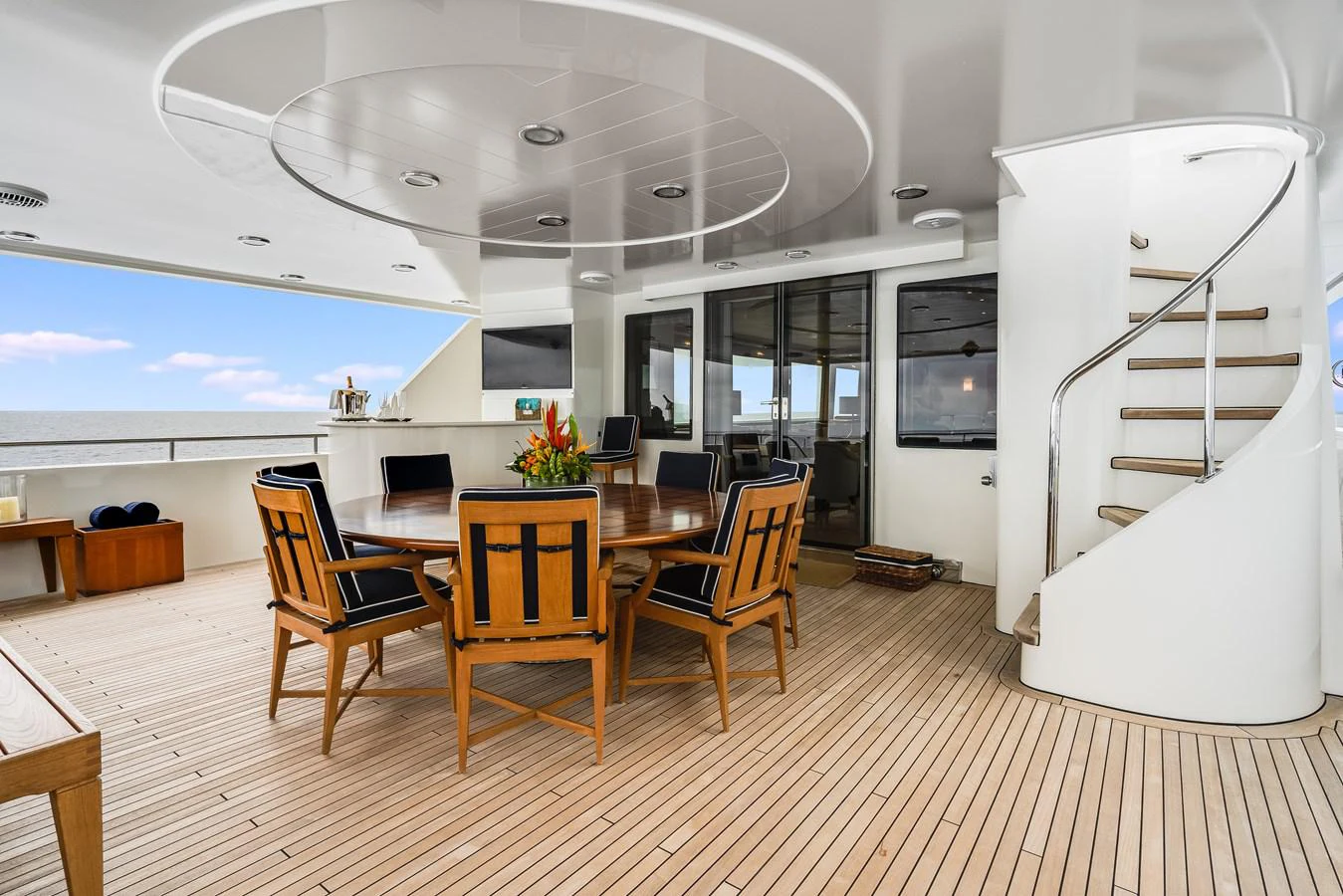 a room with a table chairs and a large window aboard DONA LOLA Yacht for Sale