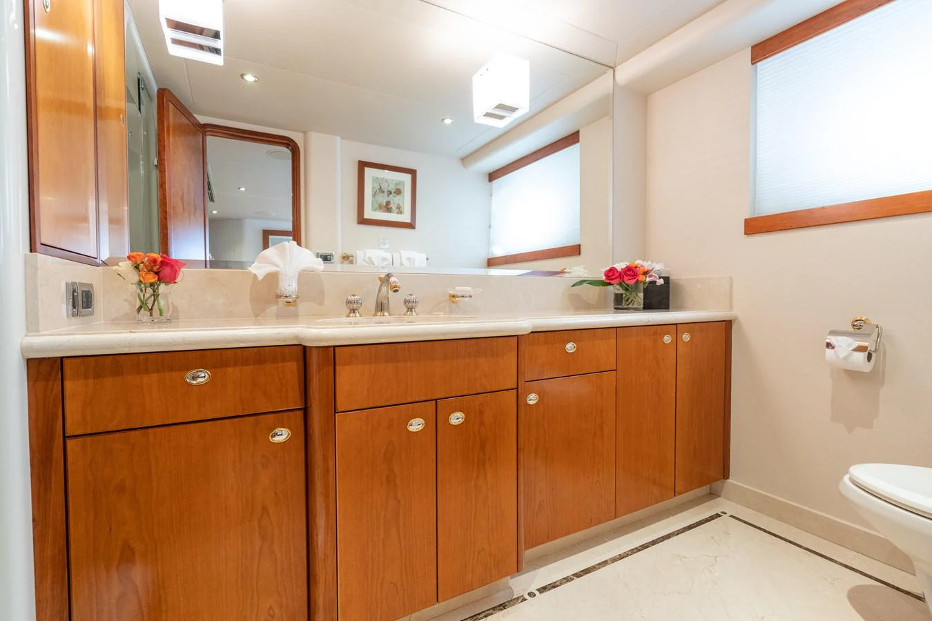 a bathroom with wooden cabinets aboard DONA LOLA Yacht for Sale