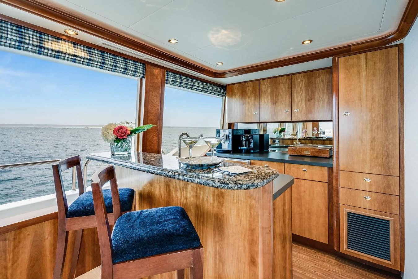 a kitchen with wooden cabinets aboard DONA LOLA Yacht for Sale