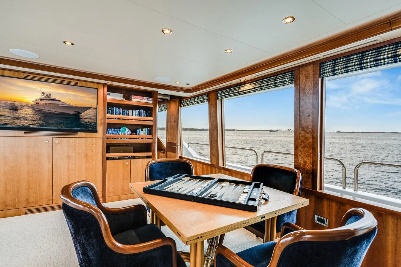 a room with a table and chairs aboard DONA LOLA Yacht for Sale