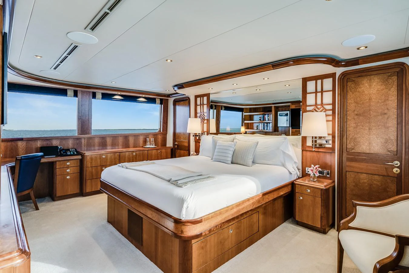 a room with a bed and a chair aboard DONA LOLA Yacht for Sale