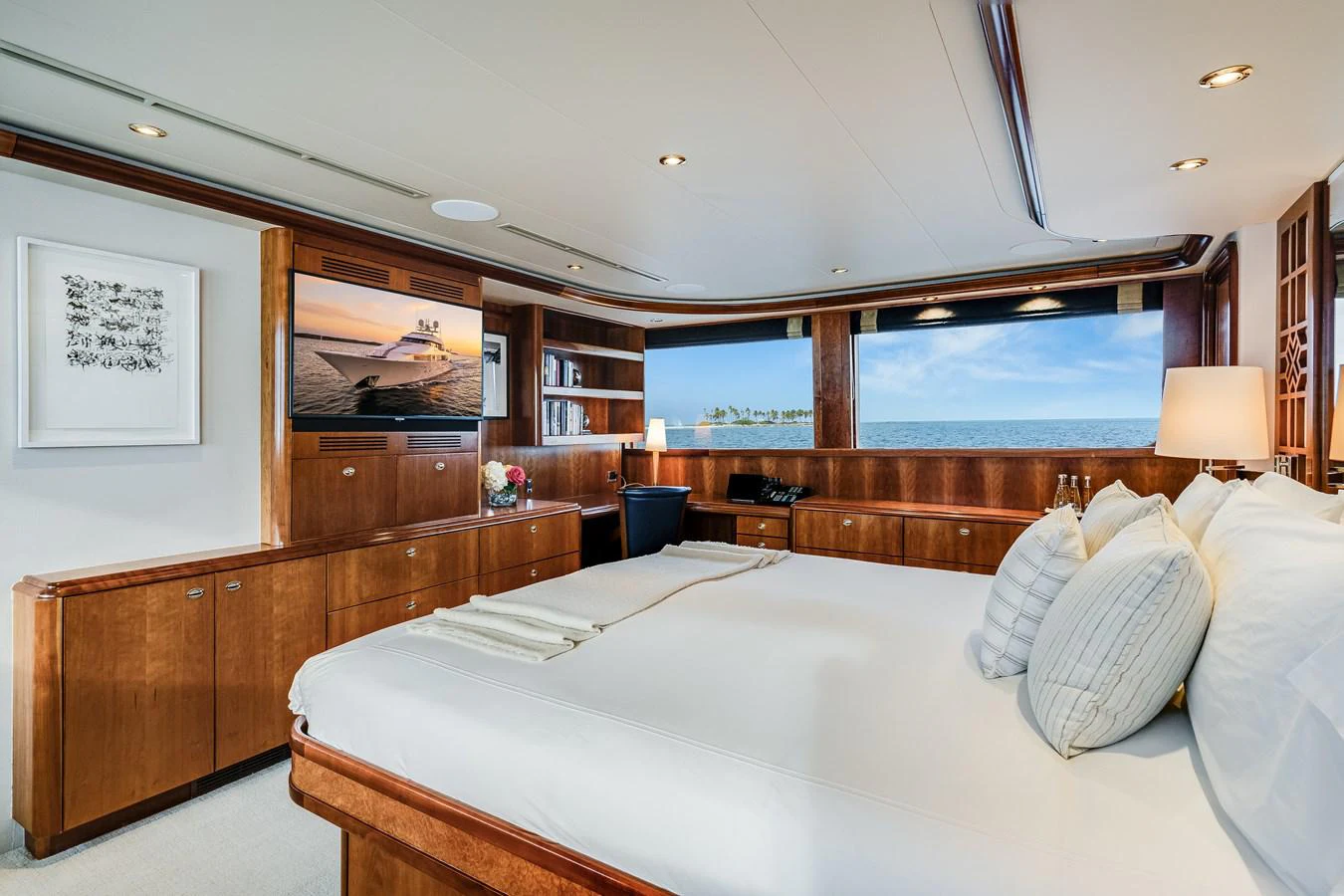 a room with a bed and a large window aboard DONA LOLA Yacht for Sale