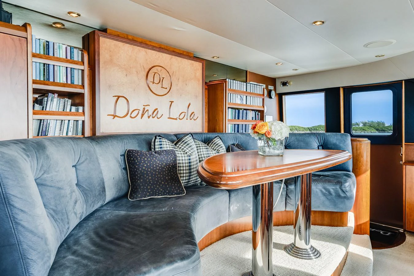 a living room with a couch and a coffee table aboard DONA LOLA Yacht for Sale