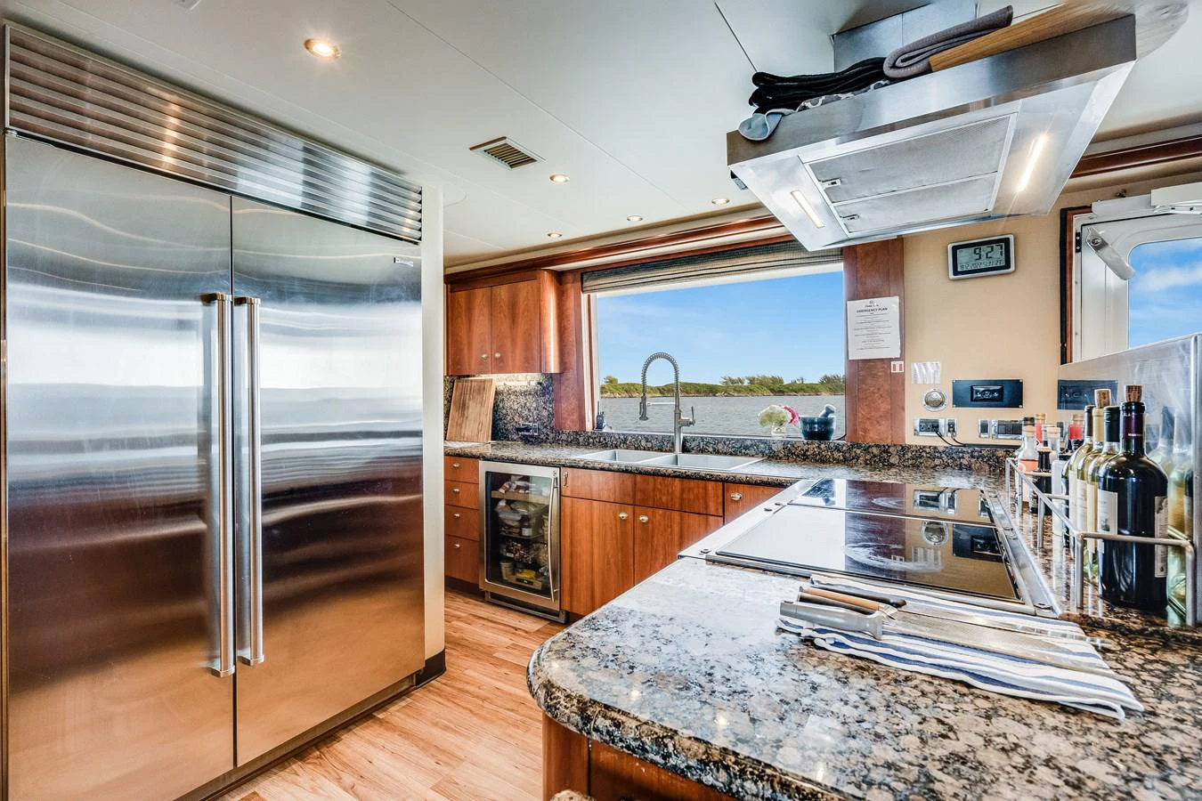 a kitchen with a stainless steel refrigerator aboard DONA LOLA Yacht for Sale