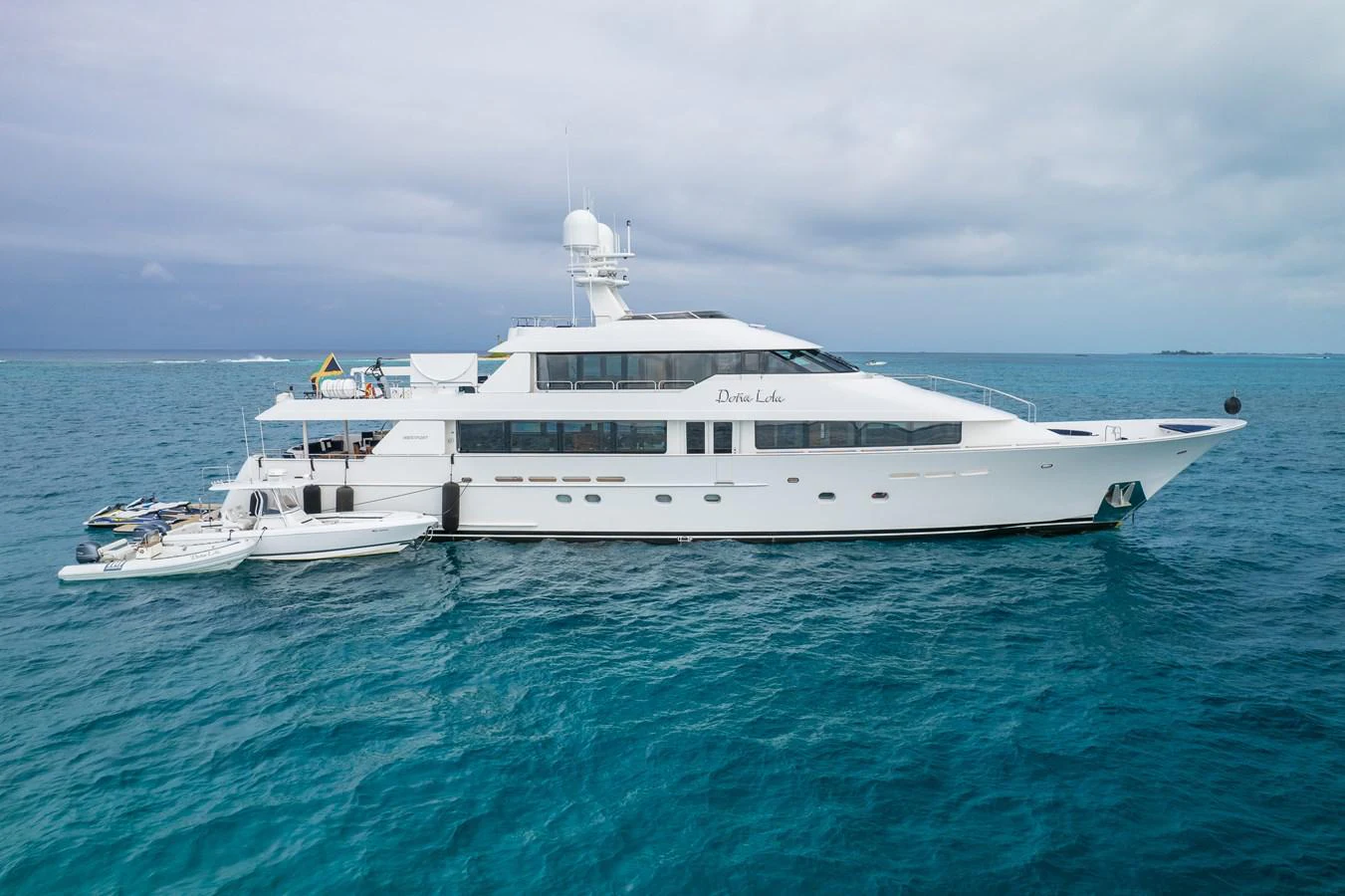 a white yacht in the water aboard DONA LOLA Yacht for Sale