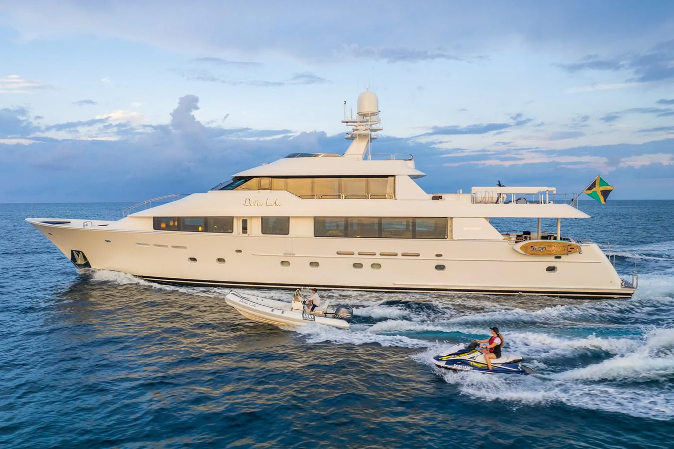 a large white ship with a couple of people in it aboard DONA LOLA Yacht for Sale