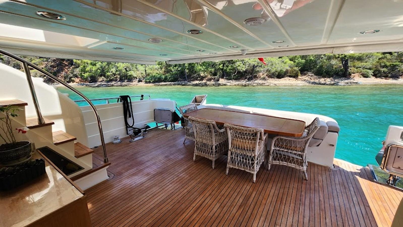 a pool with a table and chairs aboard THE ONE Yacht for Sale